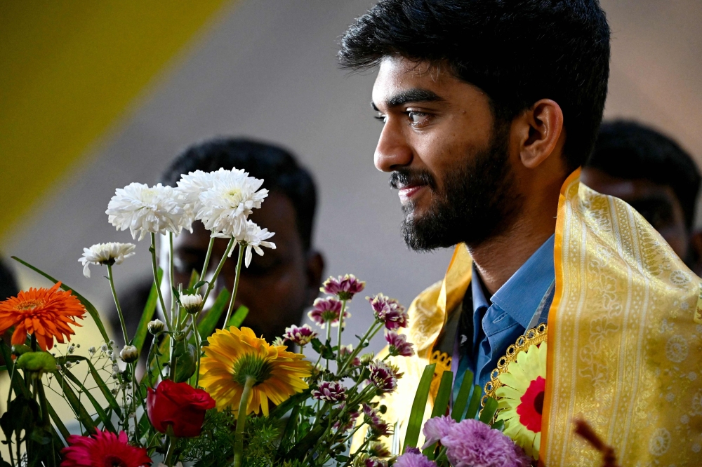 Gold medallist grandmaster Gukesh Dommaraju is greeted upon his arrival at the Chennai International Airport in Chennai on September 24, 2024, after winning the 45th FIDE Chess Olympiad Budapest 2024. — AFP pic