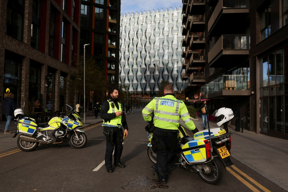 Police officers block the street near the US Embassy, amid ongoing investigation following a bomb hoax. — Reuters pic