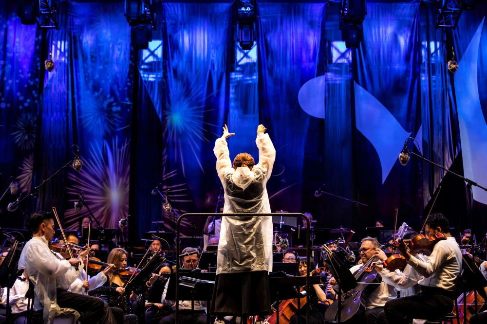 Conductor Elim Chan conducts the Hong Kong Philharmonic at an outdoor concert at the central harbour front in Hong Kong on November 16, 2024. — AFP pic