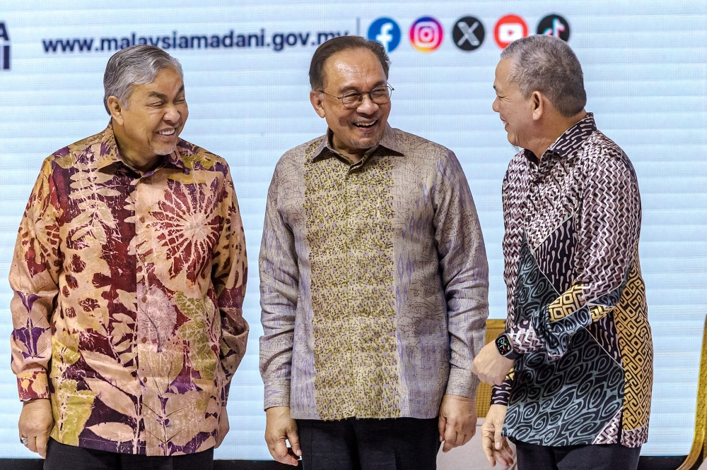 Prime Minister Datuk Seri Anwar Ibrahim speaks at a Town Hall Session during the Madani Government's two-year anniversary event at the Kuala Lumpur Convention Centre November 23. 2024 flanked by deputy prime ministers Datuk Seri Ahmad Zahid Hamidi (left) and Datuk Seri Fadillah Yusof (right). — Picture by Firdaus Latif