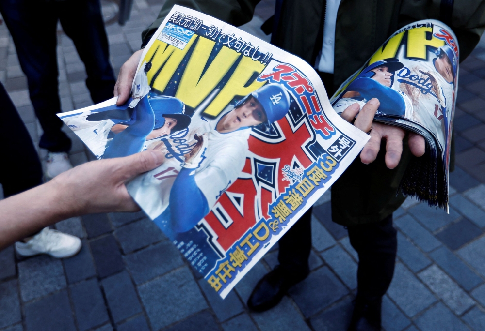 Japanese baseball fans rushed to grab the latest newspaper editions on Friday after Los Angeles Dodgers star Shohei Ohtani was named the National League’s Most Valuable Player. — Reuters pic