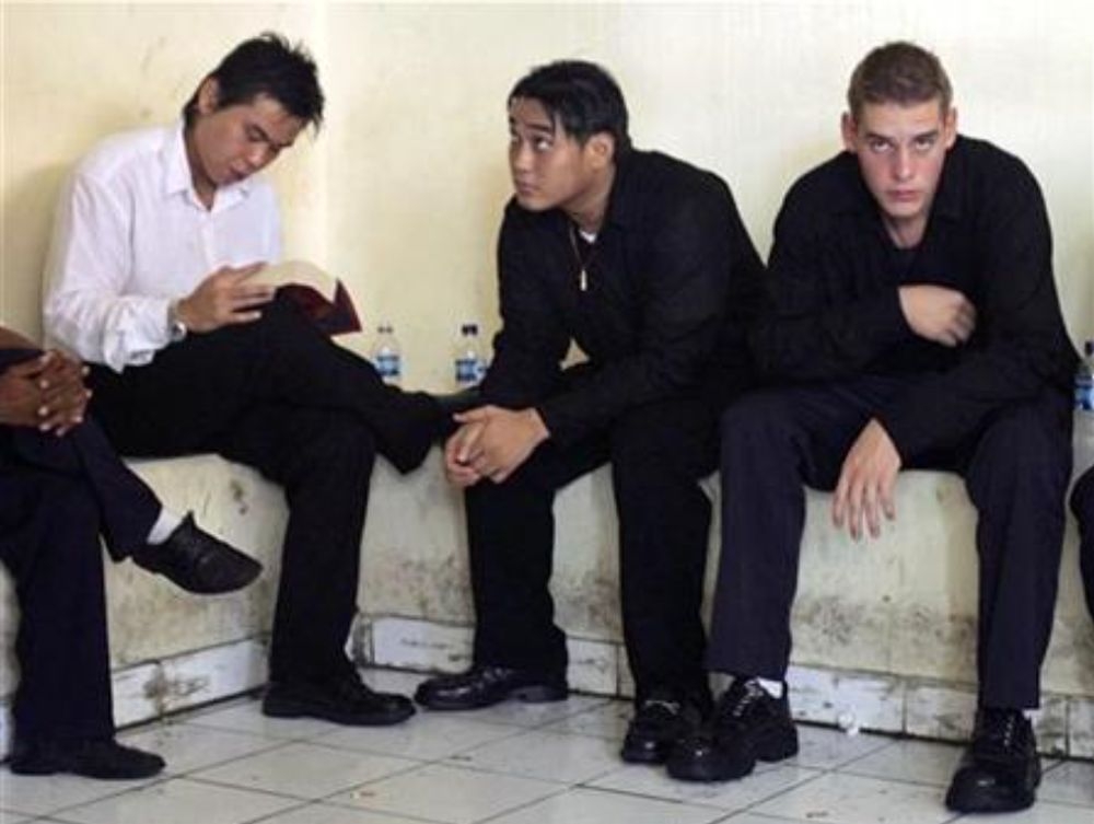 Australians (from left) Si Yi Chen, Tan Duc Thanh Nguyen, and Matthew Norman, part of the Bali Nine, wait in a temporary cell at the Denpasar court in the Indonesian island of Bali on May 9, 2007. — Reuters file pic