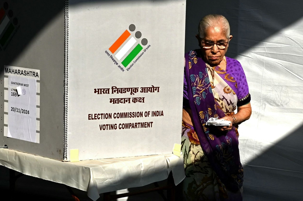 A voter leaves after casting her ballot at a polling booth during the Maharashtra state election in Mumbai, India on November 20, 2024. — AFP pic
