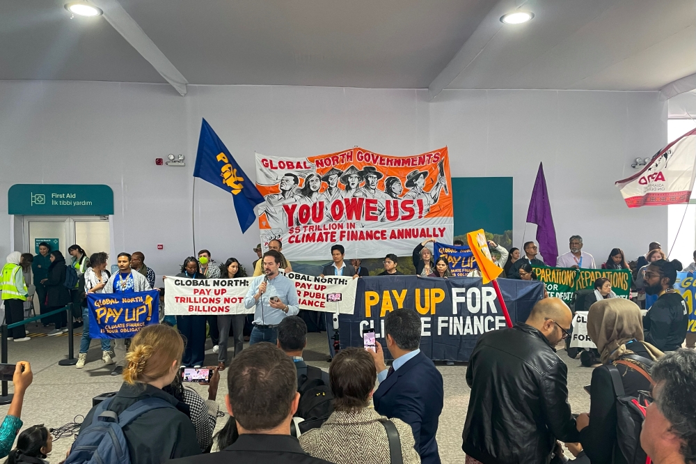 Activists with banners and flags hold a gathering to demand that rich countries help developing nations tackle global warming, during the UN Climate Change Conference (COP29) in Baku, Azerbaijan, on November 21, 2024. — AFP pic