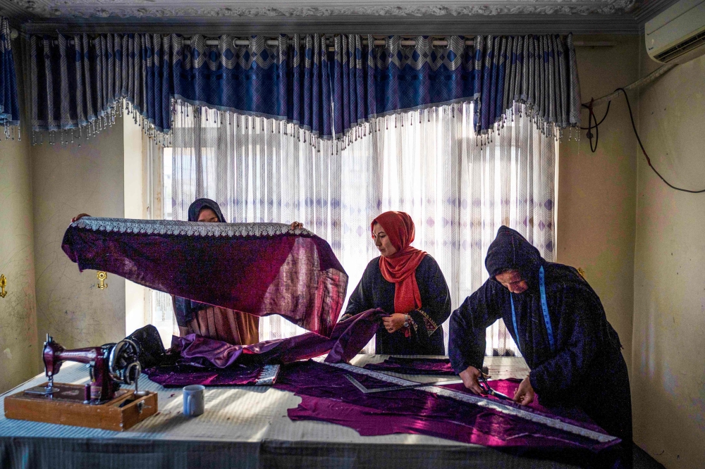 Afghan women sew clothes at a handicraft workshop in Kabul November 10, 2024. — AFP pic