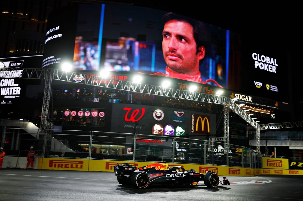 Max Verstappen of the Netherlands driving the Oracle Red Bull Racing RB20 on track during the F1 Grand Prix of Las Vegas on November 23, 2024 with banners around the circuit featuring fast food brands. — AFP pic