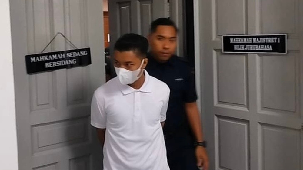 Religious teacher Mohd Zulkurnain Mohd Zain being escorted out of the Johor Baru Sessions Court courtroom after he claimed trial to seven counts of rape and physical sexual assault of a disabled student November 25, 2024. — Picture by Ben Tan 