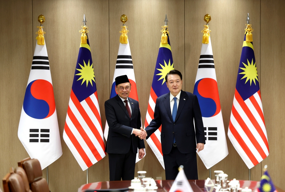 Prime Minister Datuk Seri Anwar Ibrahim (left) shakes hands with South Korean President Yoon Suk-yeol during his official visit to South Korea November 25, 2024. — Bernama pic
