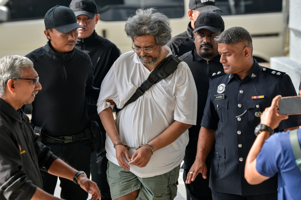 N. Deanesh (third from right) is escorted traffic policemen to a Magistrate's Court in Kuala Lumpur on Nov 26, 2024. — Bernama pic