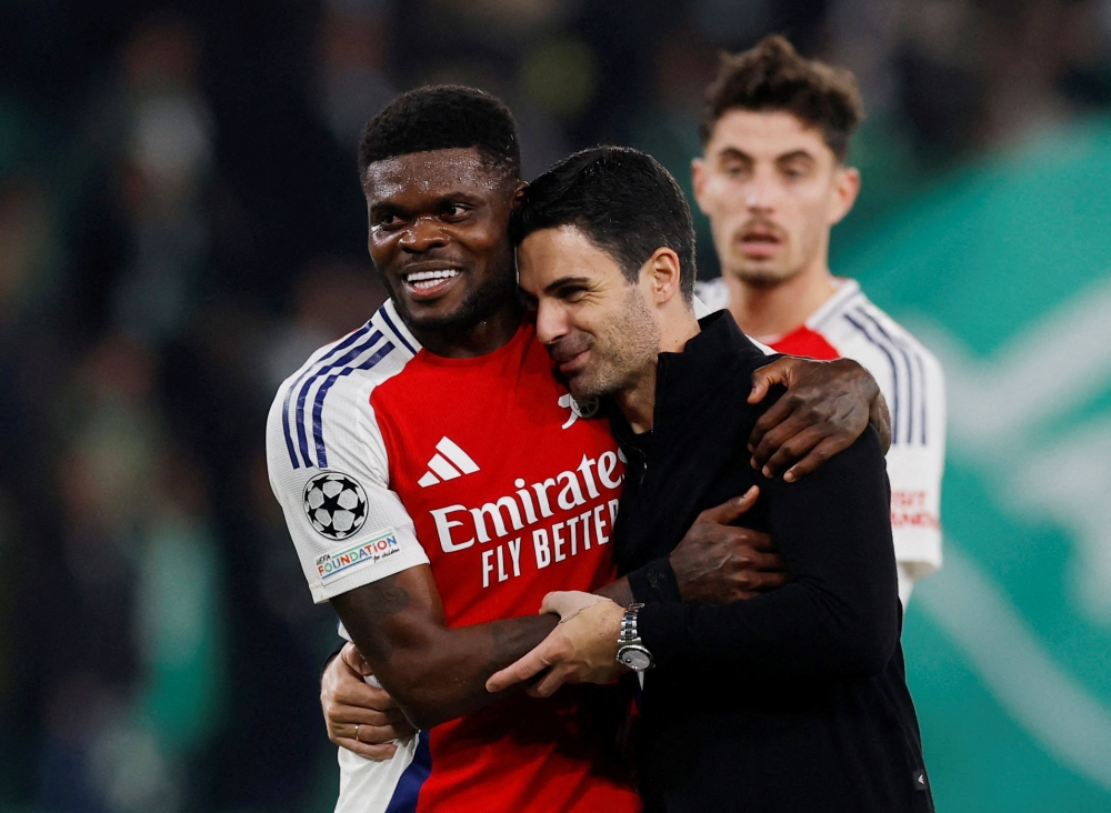 Arsenal's Thomas Partey and manager Mikel Arteta celebrate after the match.  — Action Images via Reuters pic