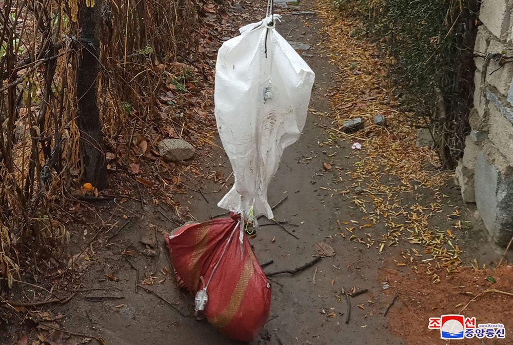 This picture taken and released from North Korea's official Korean Central News Agency (KCNA) via KNS on November 26, 2024 shows goods reportedly sent across the border via a balloon from South Korea, at an unconfirmed area near the border on the North Korean side. — KCNA pic via Reuters