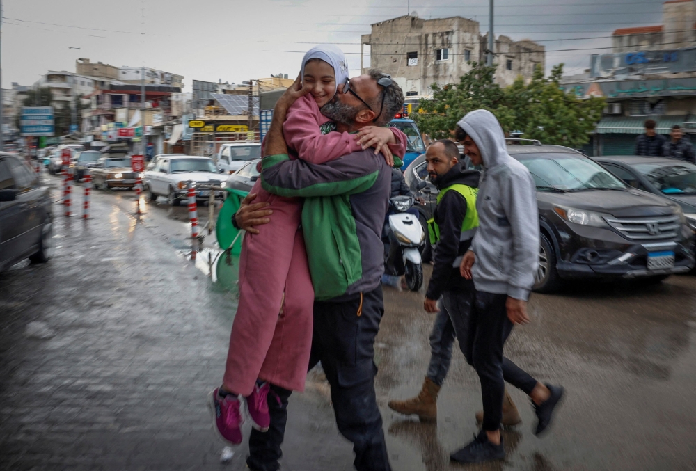 Mohammed Sleem hugs his daughter Menisa Sleem whom he had not seen in two months, after a ceasefire between Israel and Iran-backed group Hezbollah took effect in Tyre, Lebanon, November 27, 2024. — Reuters pic