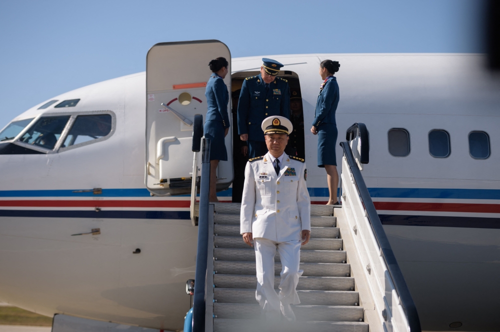 Miao Hua (centre), China’s director of the political affairs department of the Central Military Commission, disembarks his aircraft after arriving at Pyongyang International Airport, North Korea on October 14, 2019. — AFP pic
