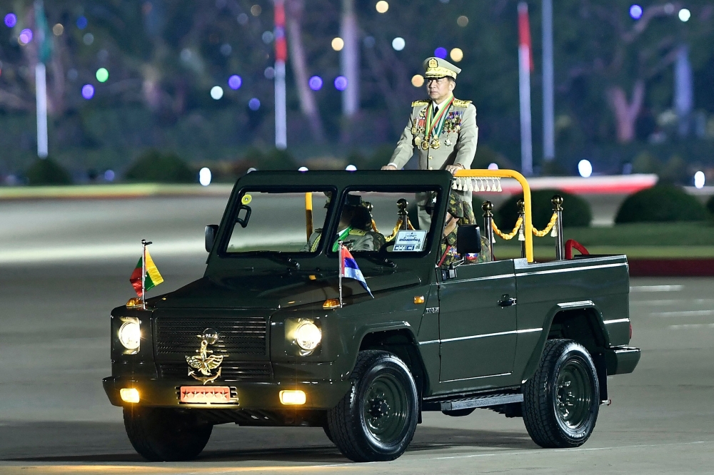 Myanmar’s military junta chief Min Aung Hlaing who led a deadly campaign against the Rohingya, is seen in a military car during a ceremony to mark the country’s Armed Forces Day in Naypyidaw on March 27, 2024. — AFP pic