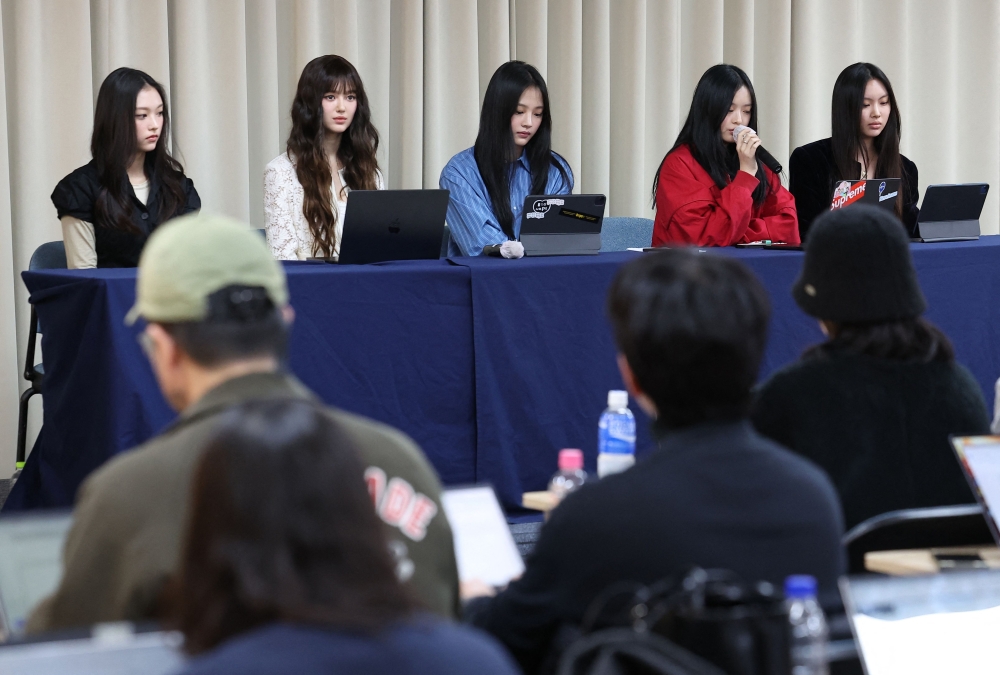 South Korean K-pop girl group NewJeans members (from left) Haerin, Danielle, Minji, Hanni and Hyein attend a press conference in Seoul November 28, 2024. — AFP pic