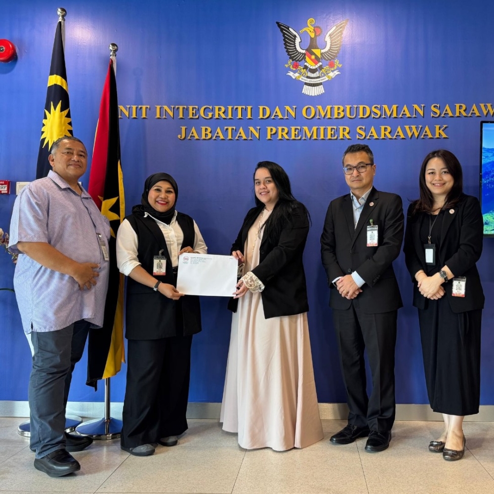 A Unions representative (centre) receives the invitation letter. — The Borneo Post pic