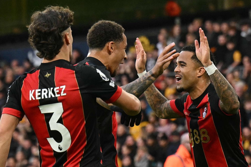 Bournemouth’s Dutch striker #19 Justin Kluivert (far right) celebrates scoring the team’s third goal with Bournemouth’s Scottish midfielder #10 Ryan Christie (centre) and Bournemouth’s Hungarian defender #03 Milos Kerkez during the English Premier League football match between Wolverhampton Wanderers and Bournemouth at the Molineux stadium in Wolverhampton, central England on November 30, 2024. — AFP pic