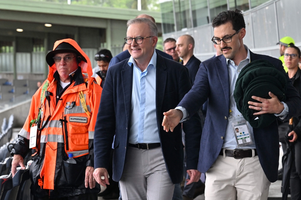 ​​Australian Prime Minister Anthony Albanese (centre) says he is willing to with X boss Elon Musk who has been criticising Australia’s new ban on minors below age 16 from using socia media. — AFP pic