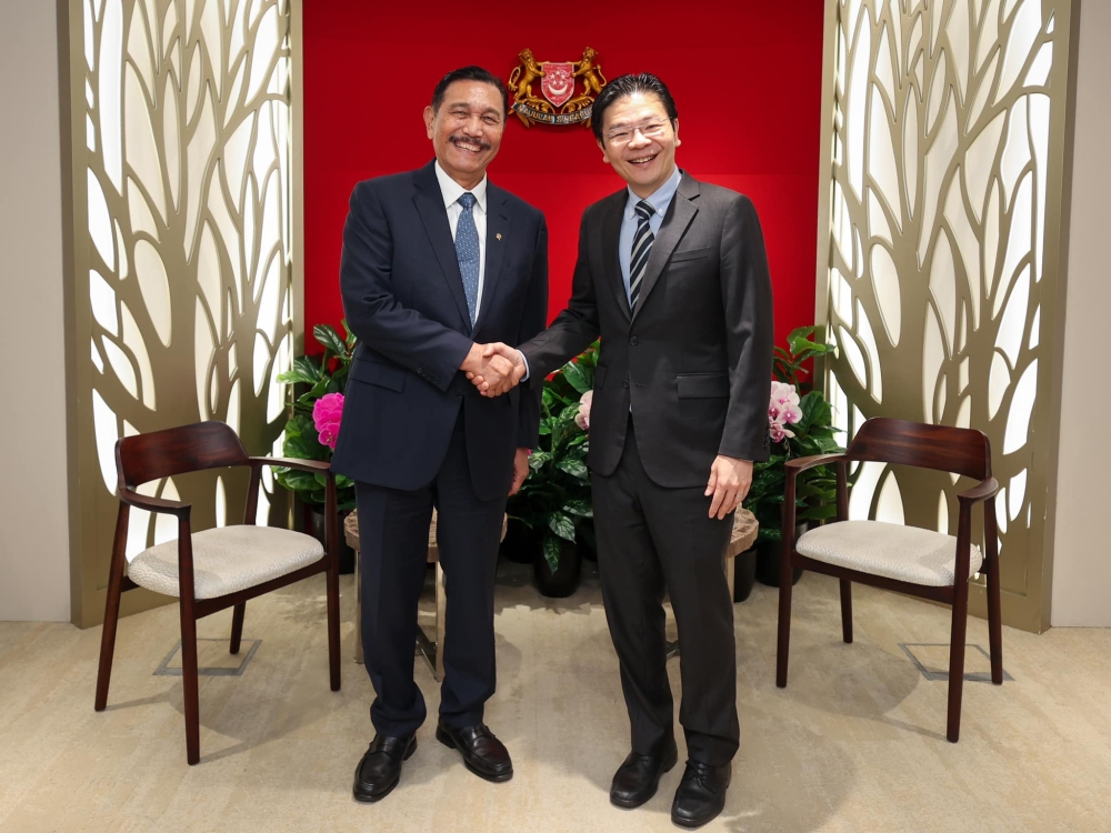 Luhut Pandjaitan (left), chairman of Indonesia’s National Economic Committee, poses for pictures with Singapore Prime Minister Lawrence Wong during a meeting on April 23, 2024 in Singapore. — Picture from Facebook/Lawrence Wong