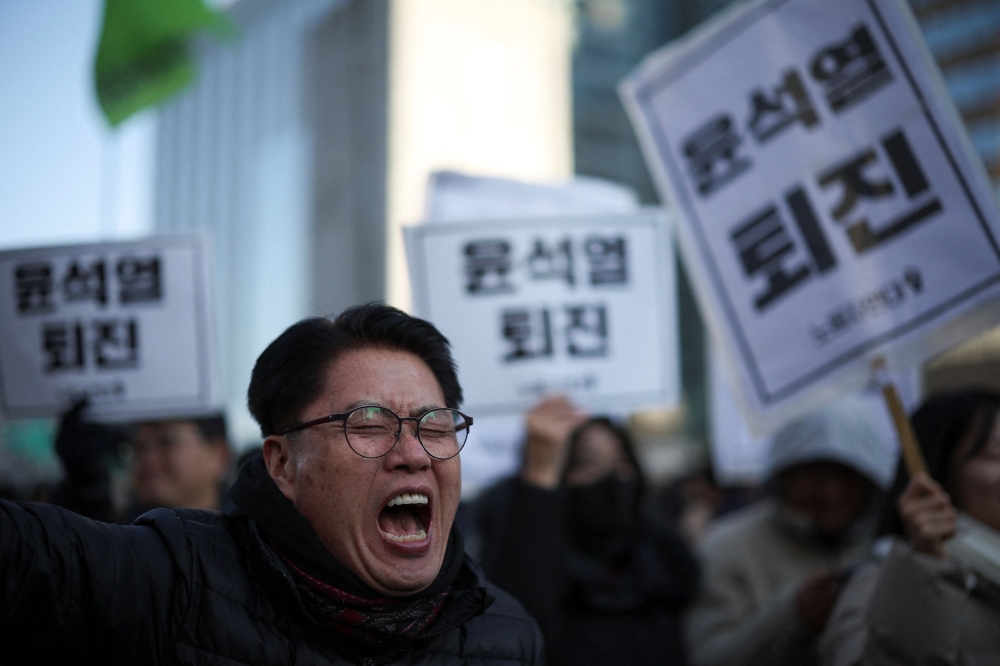 A man chants slogans during a rally calling for the resignation of South Korean President Yoon Suk-yeol in Seoul December 4, 2024. — Reuters pic