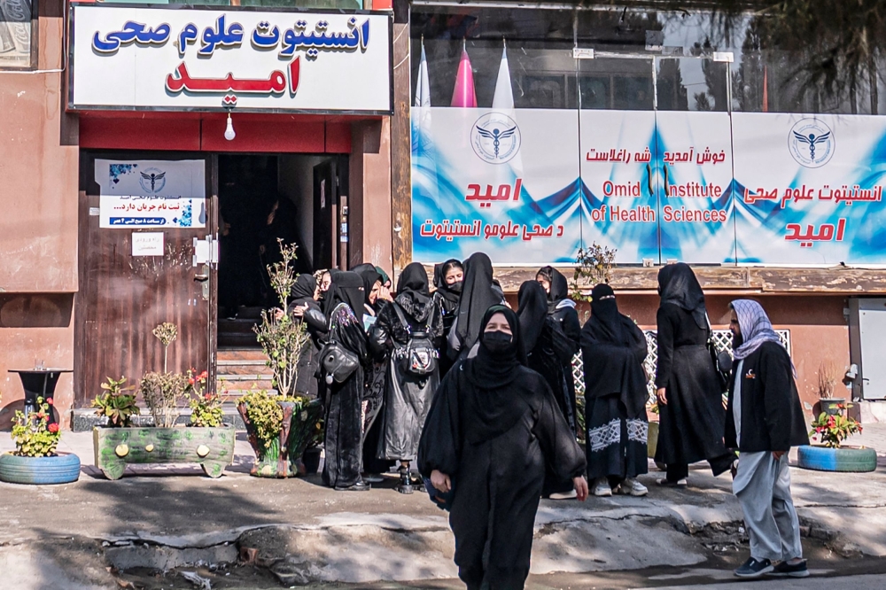 Afghan female students studying health studies gather outside the Omid Institute of Health Sciences in Kabul on December 3, 2024. — AFP pic 