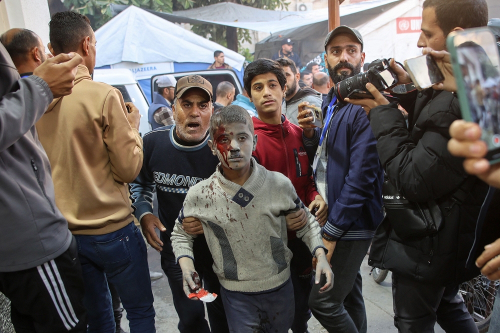 An injured boy is evacuated after an Israeli strike in Gaza City’s Sabra neighbourhood, on December 3, 2024. With brutal conflicts spiralling in places like Gaza, Sudan and Ukraine, and as climate change and extreme weather take an ever-heavier toll, the UN estimated that 305 million people globally will need some form of emergency assistance next year. — AFP pic 