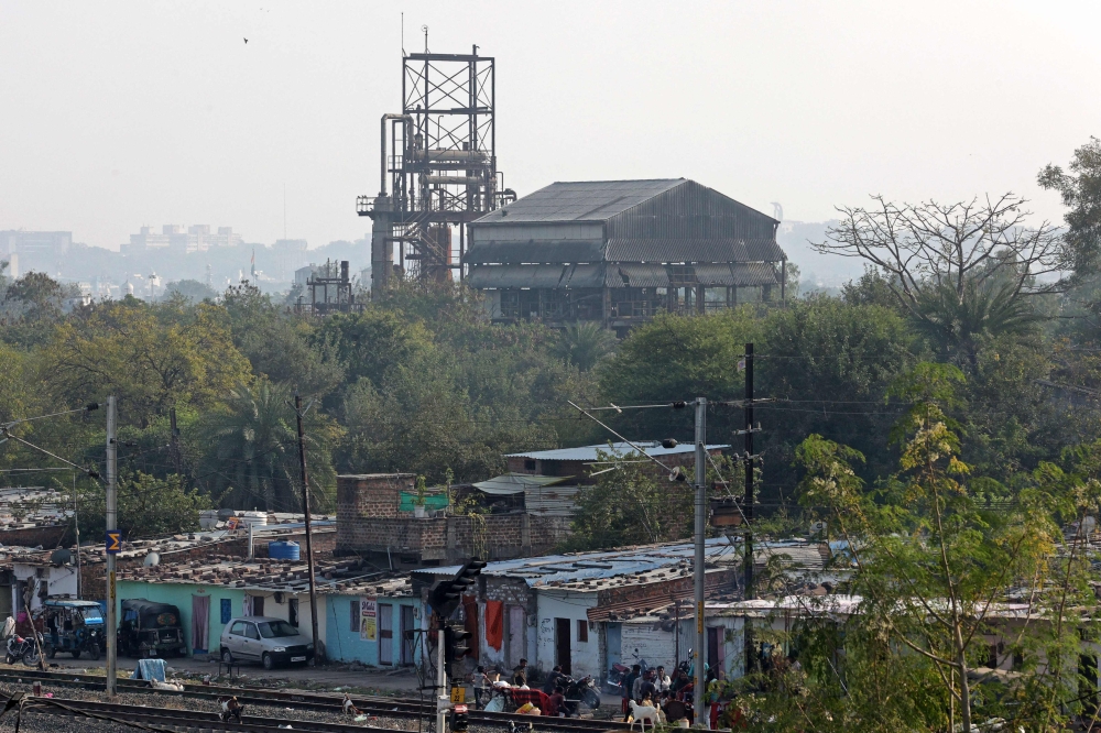 This photograph taken on November 25, 2024 shows a general view of the defunct Union Carbide factory (back) in the aftermath of the 1984 Bhopal Gas Leak Disaster, behind a slum settlement in Bhopal. — AFP pic