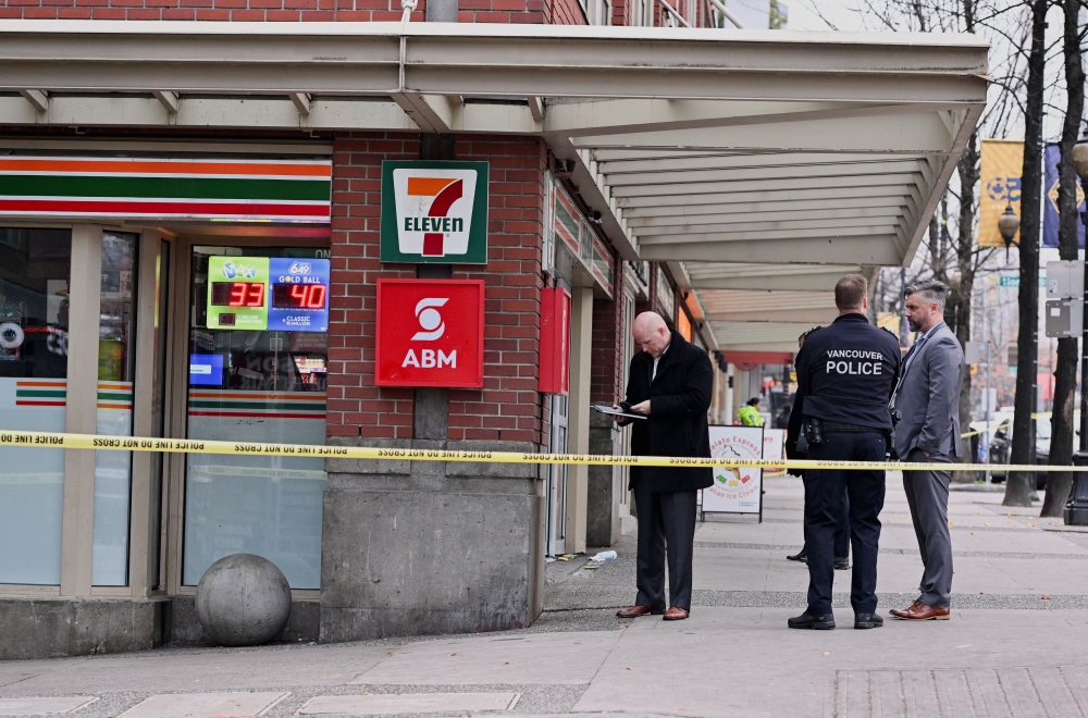 Vancouver Police Department officers secure the scene of what they described as a violent incident where a number of people were stabbed and the suspect was shot by police, in downtown Vancouver, British Columbia, Canada December 4, 2024. 