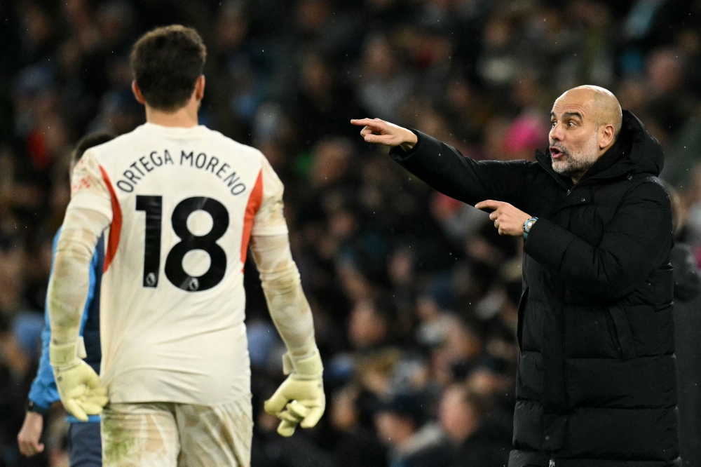 Manchester City's Spanish manager Pep Guardiola gives instructions to Manchester City's German goalkeeper #18 Stefan Ortega from the touchline during the English Premier League football match between Manchester City and Nottingham Forest at the Etihad Stadium in Manchester December 4, 2024. — AFP pic