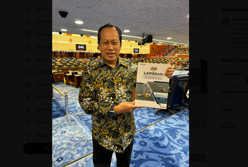Deputy Works Minister Datuk Seri Ahmad Maslan holds up a copy of the declassified papers on Pulau Batu Puteh RCI report in the Dewan Rakyat on December 5, 2024. — Picture from X/ahmadmaslan