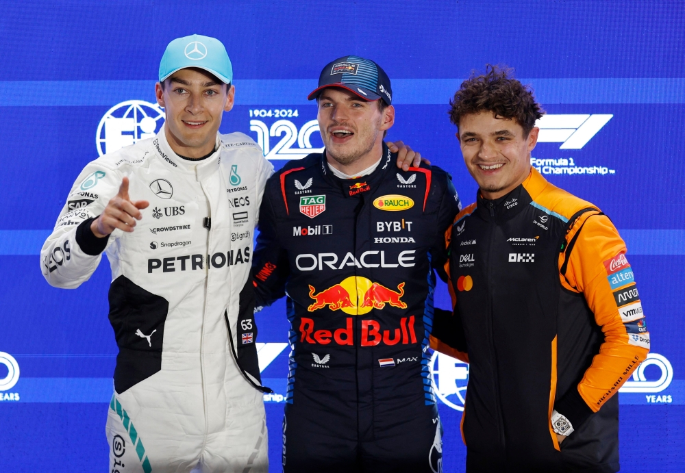 Red Bull’s Max Verstappen with Mercedes’ George Russell and McLaren’s Lando Norris. — Reuters pic