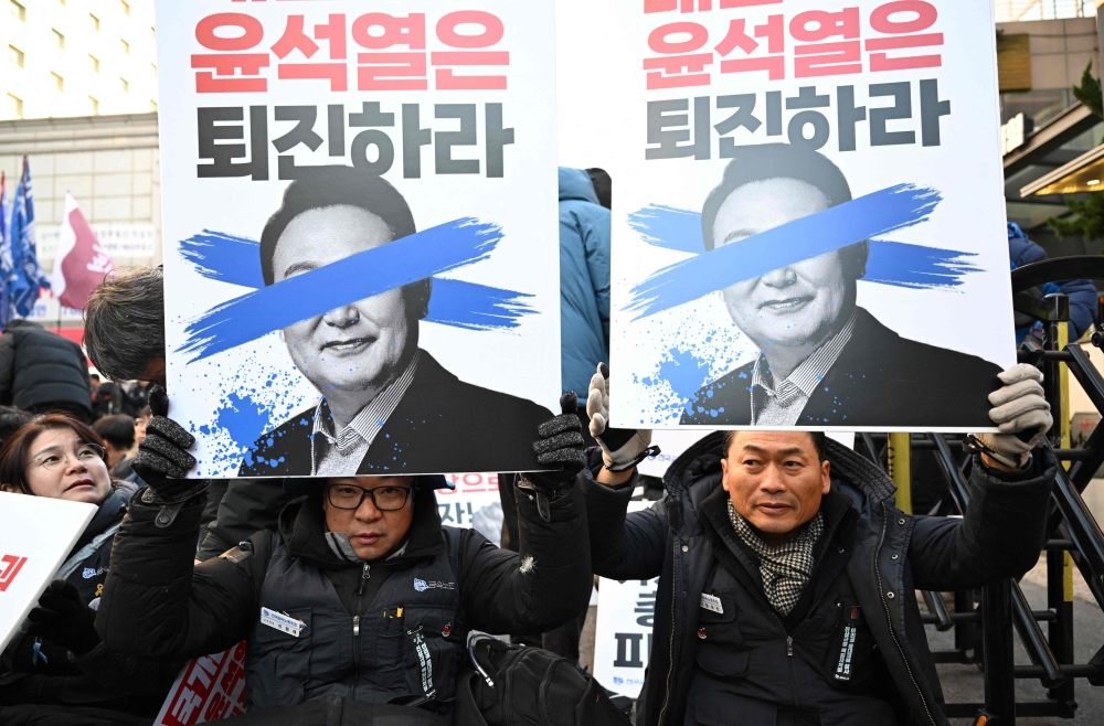 South Korean President Yoon Suk-yeol will address the nation this morning, his office said, ahead of a planned impeachment vote over his attempt this week to impose martial law. — AFP pic