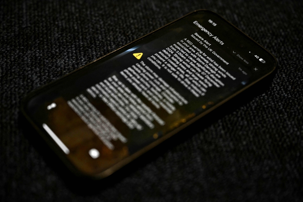 The UK’s weather agency issued a rare red alert for high winds yesterday as the government warned three million Britons to brace themselves for the impact of Storm Darragh. — AFP pic