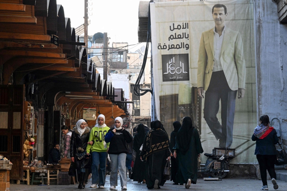 A portrait of Syria's President Bashar al-Assad is displayed in the old city of Syria's capital Damascus on December 6, 2024. — AFP pic