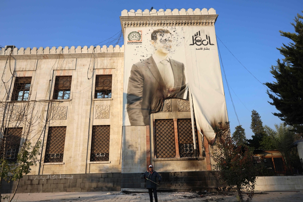 A portrait of Syrian President Bashar al-Assad on a government building in Hama. — AFP pic