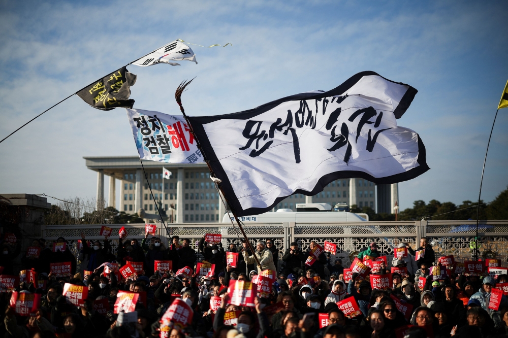Protestors take part in a rally calling for the impeachment of South Korean President Yoon Suk-yeol in front of the National Assembly in Seoul today. — Reuters pic