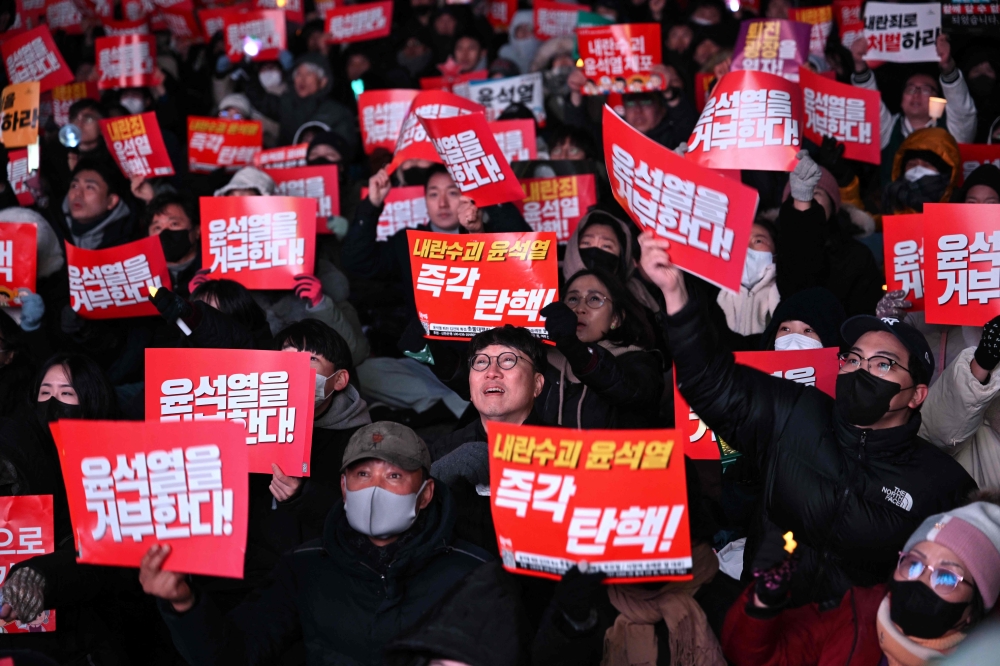 People take part in a protest calling for the ouster of South Korea President Yoon Suk Yeol outside the National Assembly in Seoul on December 7, 2024. Nearly 150,000 people attended a rally outside South Korea's parliament on December 7, Yonhap reported, demanding Yoon step down as lawmakers inside struggled to muster the votes to impeach him. — AFP pic