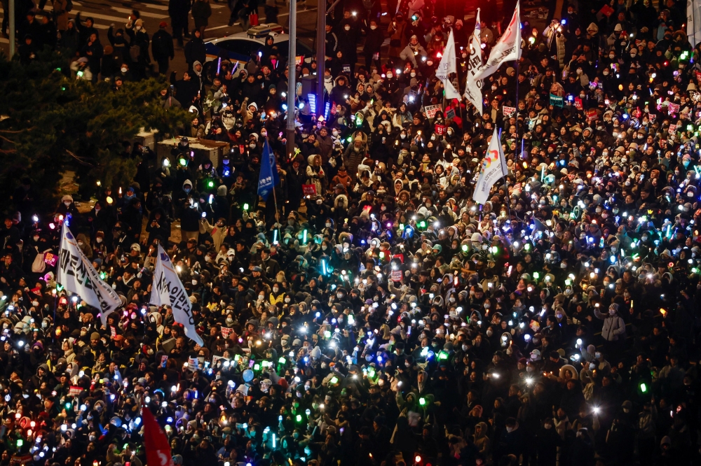Protesters take part in a rally calling for the impeachment of South Korean President Yoon Suk Yeol, who declared martial law, which was reversed hours later, near the National Assembly in Seoul December 7, 2024. — Reuters pic  