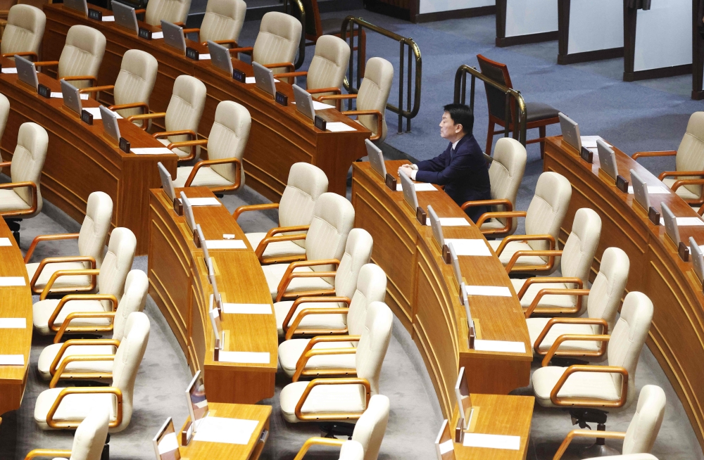 Lawmaker Ahn Cheol-soo sits alone, the only People Power Party lawmaker to remain in the voting chamber during the plenary session for the impeachment vote of President Yoon Suk Yeol at the National Assembly in Seoul December 7, 2024. — Jeon Heon-kyun/Pool/AFP pic