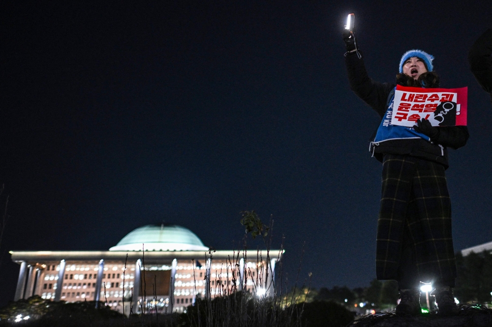 A woman takes part in a protest outside the National Assembly in Seoul yesterday. — AFP pic