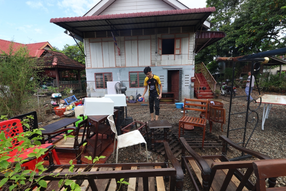 Residents put out water-logged items to dry after returning to their homes following a flood in Kampung Alor Merah near Alor Setar, Kedah, on Dec 6, 2024. — Bernama pic