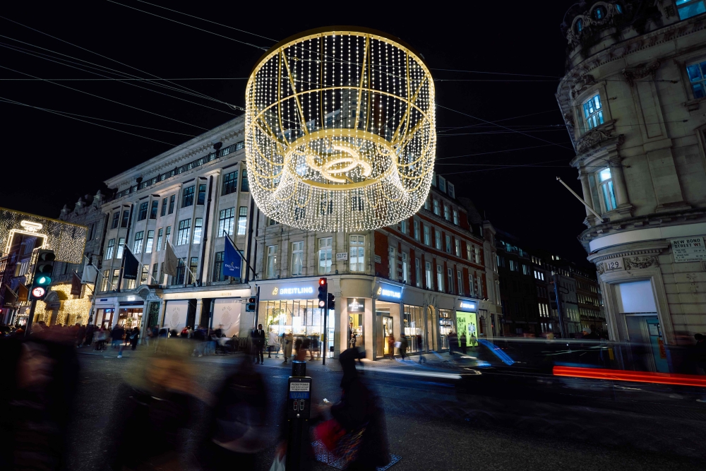 Members of the public look at the annual Christmas lights on New Bond Street in central London December 6, 2024. — AFP pic