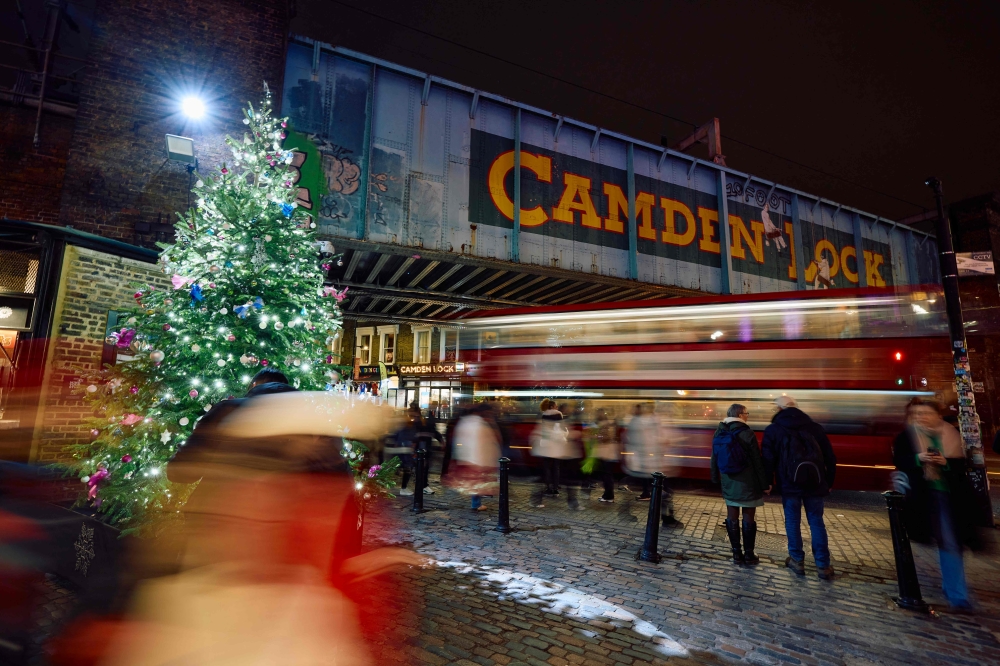 Members of the public walk past the annual Christmas lights in Camden, central London December 6, 2024. — AFP pic
