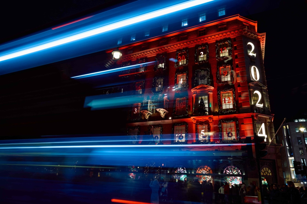 Members of the public look at the annual Christmas lights outside of the Fortnum and Mason food store in central London December 6, 2024. — AFP pic