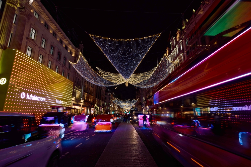 Buses and cars drive past the annual Christmas lights on Regent Street in central London December 6, 2024. Companies are to spend a record £10.5 billion (RM58 billion) on mostly online UK promotion of products during the present Christmas season, according to data from WARC and the Advertising Association, a British trade body. — AFP pic