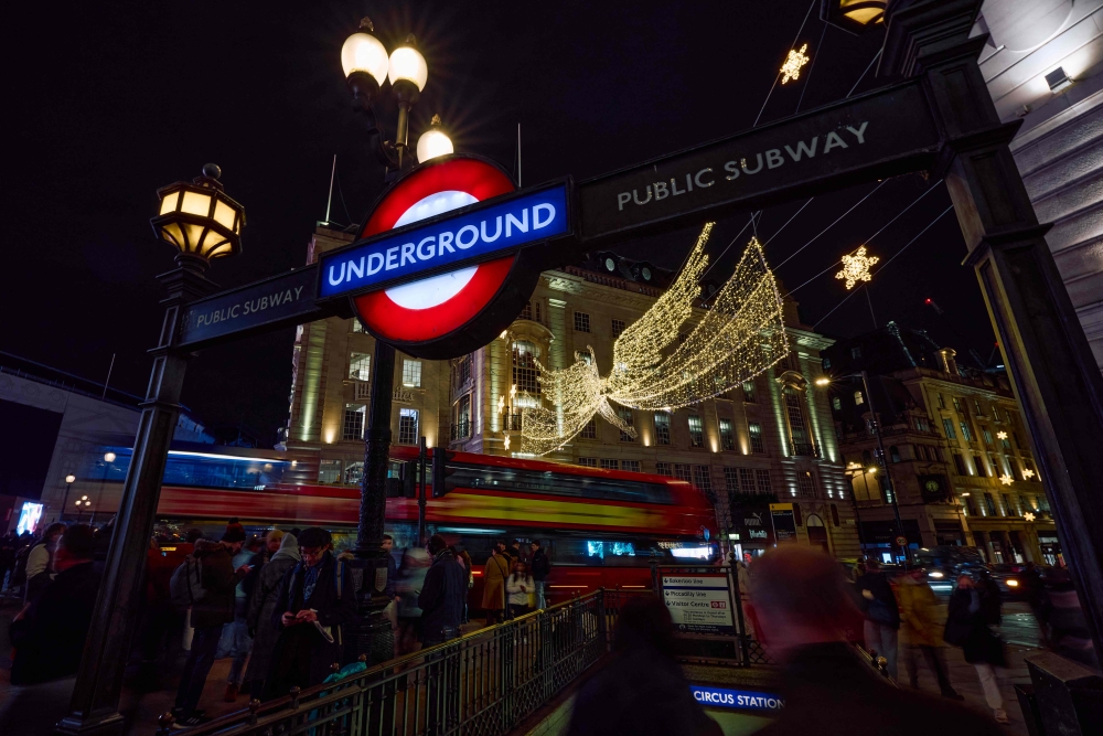 Buses drive past the annual Christmas lights on Regent Street in central London December 6, 2024. — AFP pic