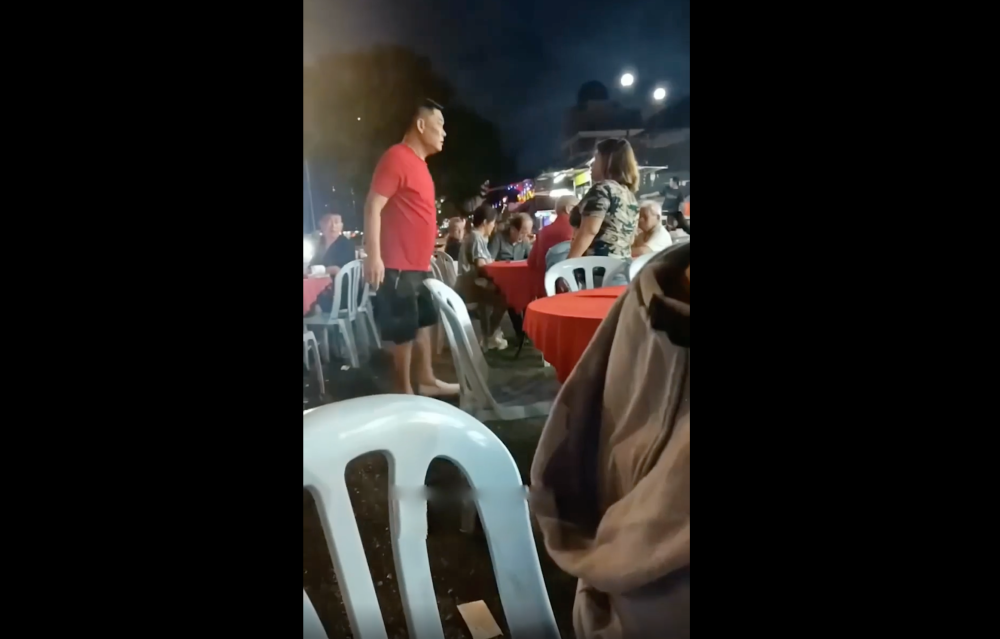 This undated confrontation between this man and woman took place at a restaurant in Stulang, Johor, and was witnessed by young children. — Screencap from video posted on r/Malaysia/whusler.