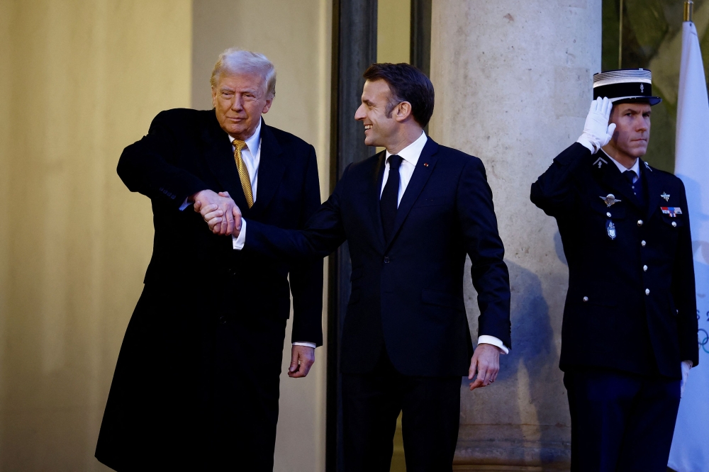 US President-elect Donald Trump and French President Emmanuel Macron shared an intense series of handshakes on Saturday, reminiscent of the white-knuckled grip-off that marked a meeting between the two leaders more than seven years ago. — Reuters pic