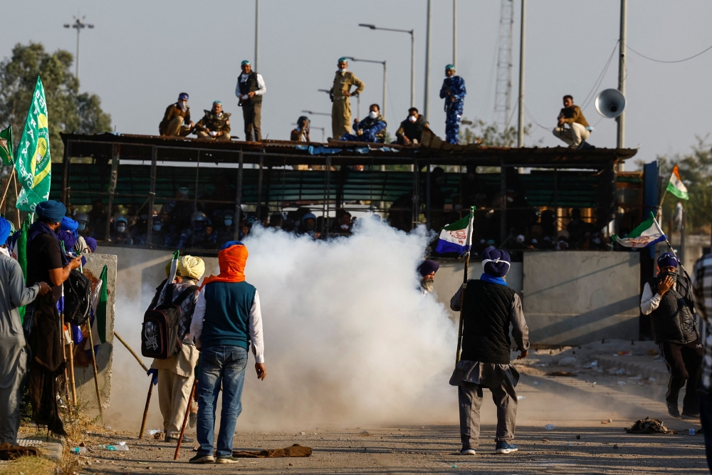 Farmers stand in front of a tear gas cloud, as they march towards New Delhi to press for better crop prices promised to them in 2021, at the Shambhu barrier, a border crossing between Punjab and Haryana states, India, December 6, 2024. — Reuters pic  