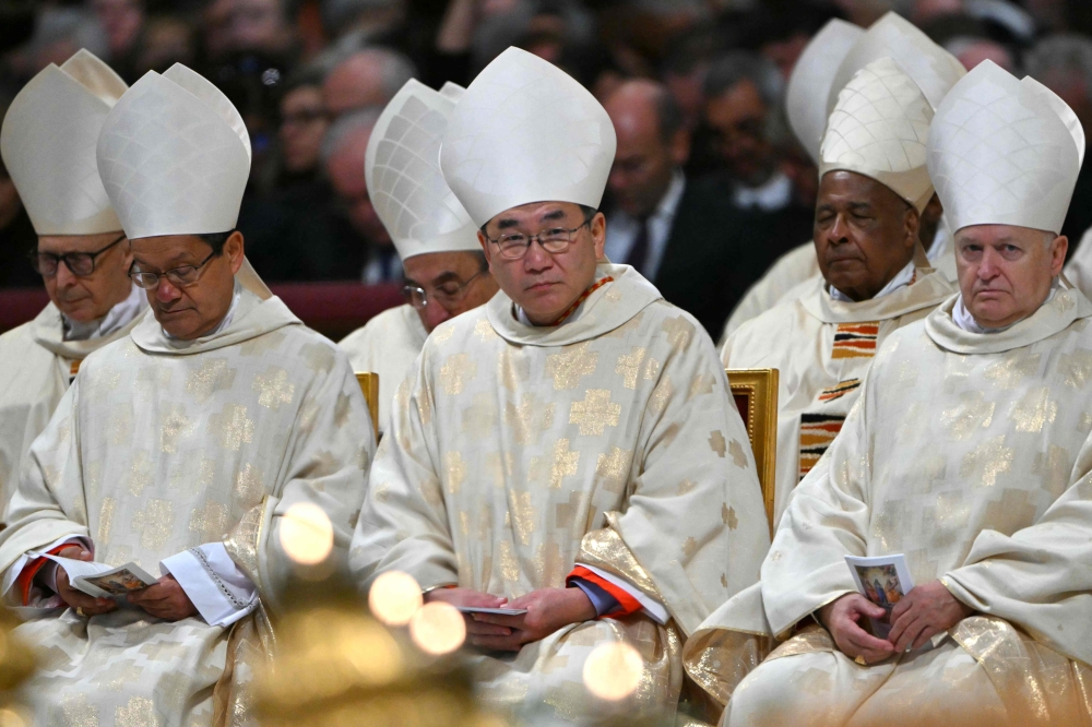 Equatorian cardinal Luis Gerardo Cabrera Herrera  (left), Japanese cardinal Tarcisio Isao Kikuchi (centre) and Hungarian cardinal Ladislav Nemet (right) attend Mass with the newly appointed cardinals at St Peter’s basilica in The Vatican, on December 8, 2024. — AFP pic